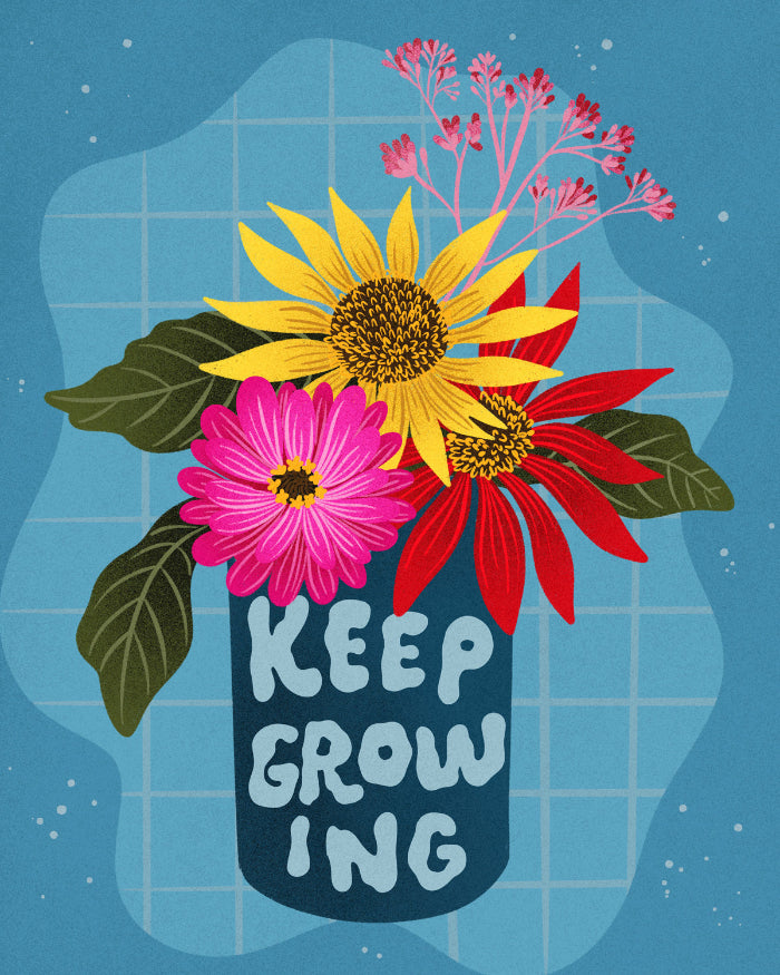 A vase with flowers that reads "keep growing"