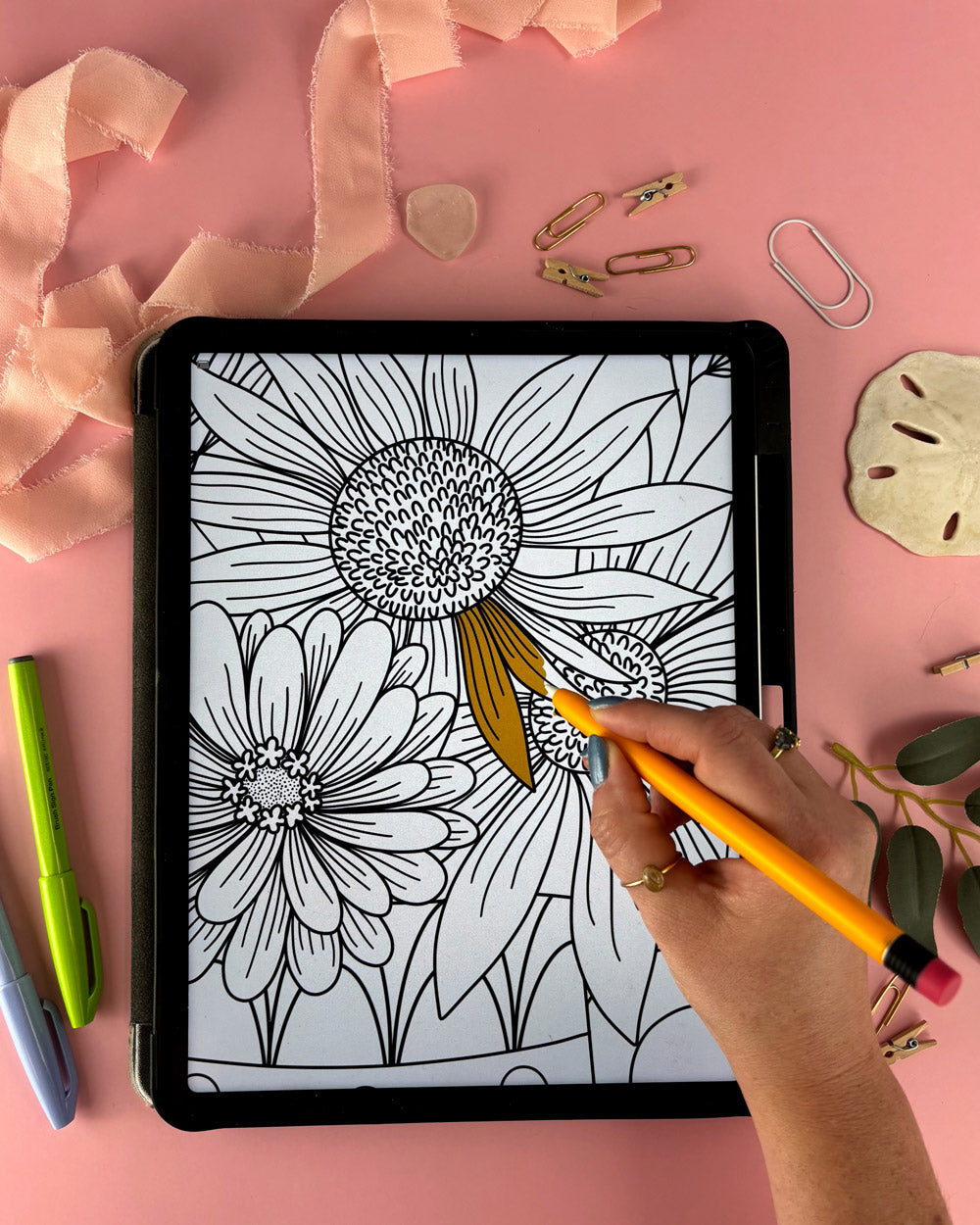A person coloring a flower bouquet on an ipad