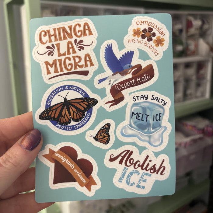 a hand holding a sticker sheet that says 