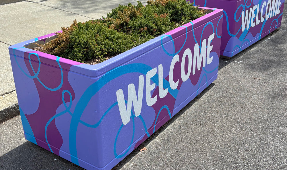 vibrant and colorful mural on concrete planter road barrier