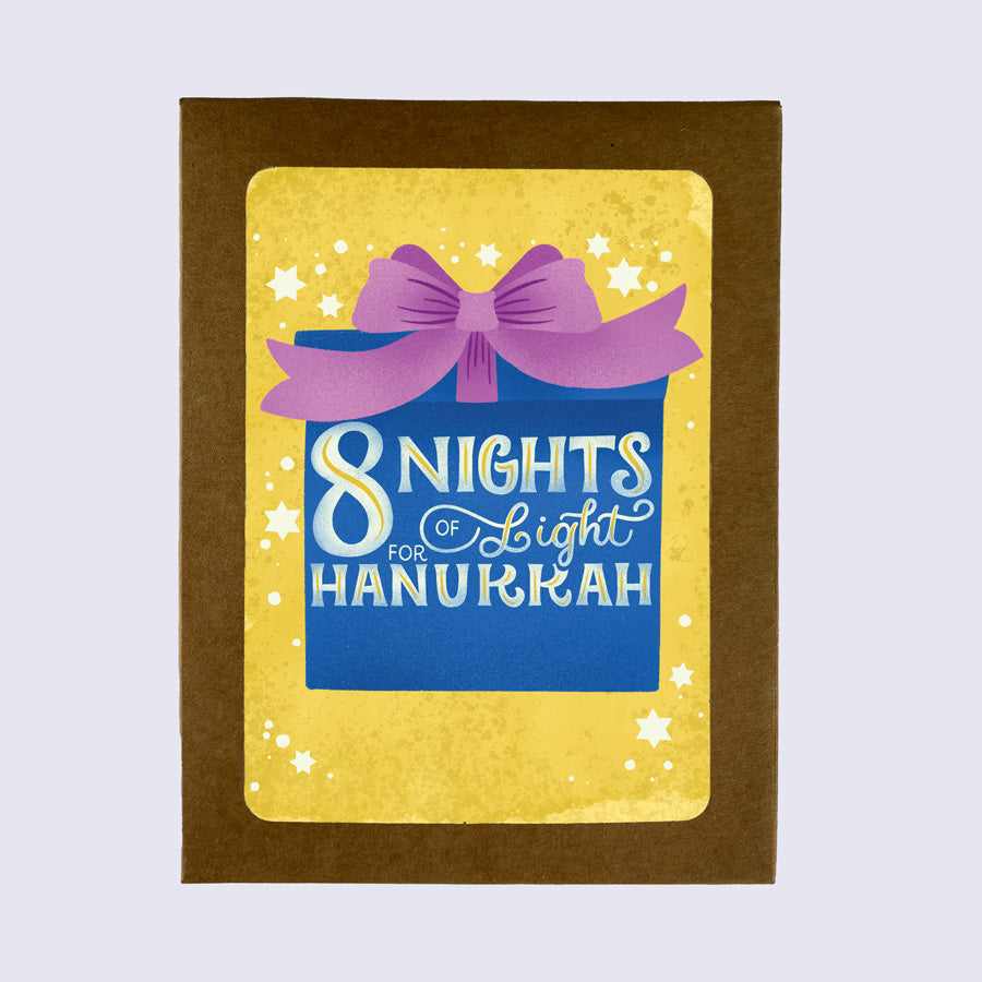 greeting card of a wrapped gift that says "8 nights of light for hanukkah" on a yellow background
