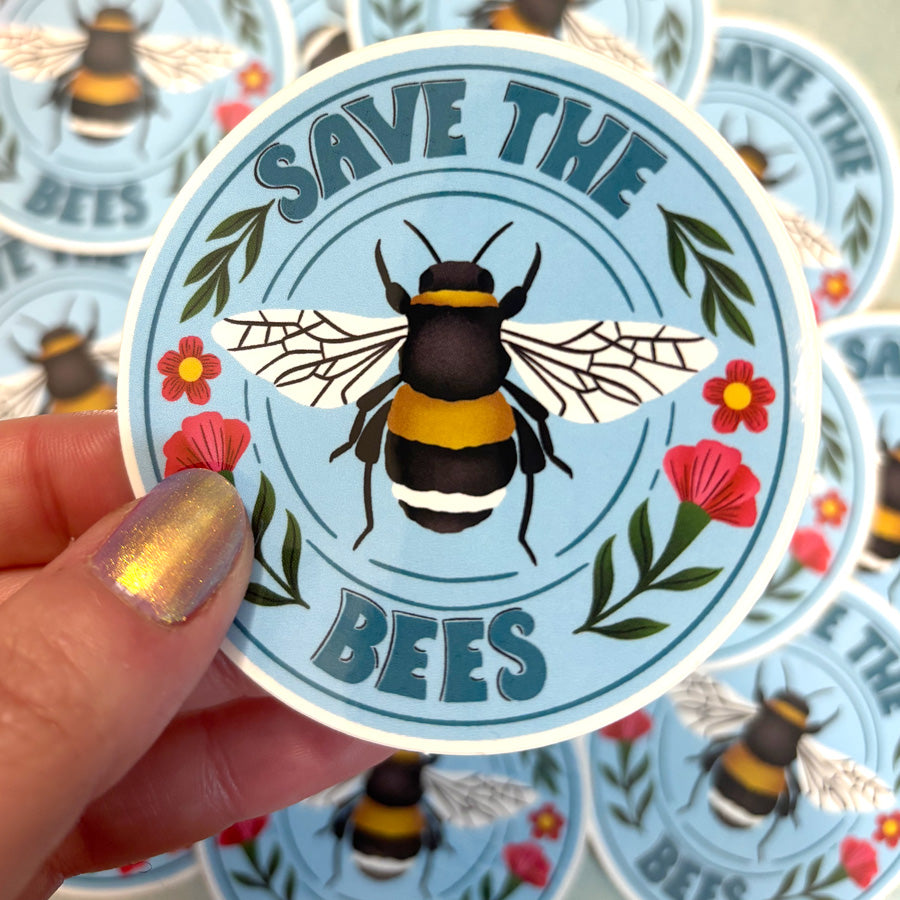 Sticker with a bee illustration and 'Save the Bees' text held by a hand.