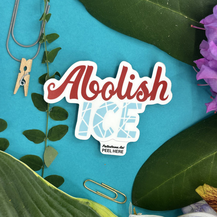 Sticker with 'Abolish Ice' design on a blue background with leaves and flowers.