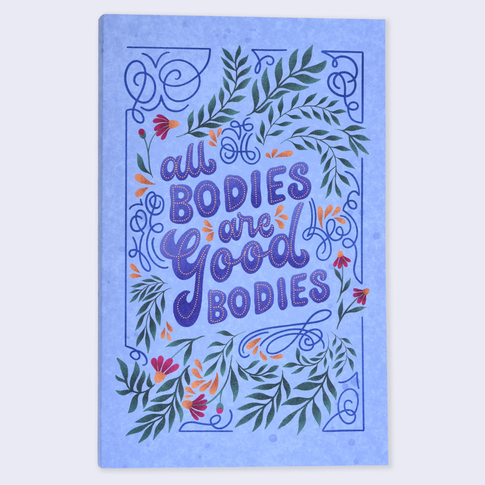 a blue notebook with flower illustrations and text "all bodies are good bodies"