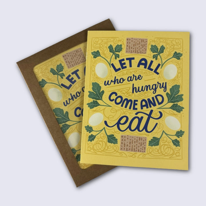 Yellow card with blue text that reads "let all who are hungry come and eat" and illustrations of matza, parsley, and eggs
