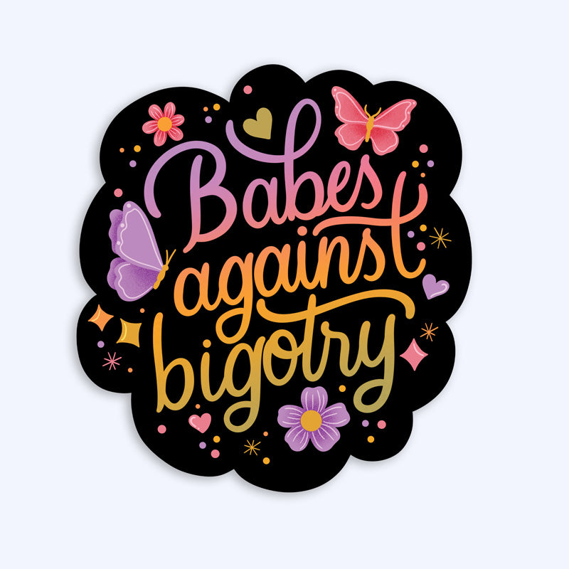 A sticker with a black background featuring the text 'Babes against bigotry' in a yellow to pink gradient, surrounded by purple and pink butterflies and flowers.