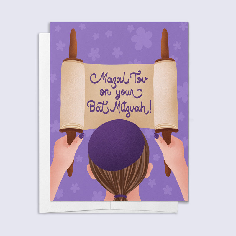 Greeting card with hands holding a Torah scroll and 'Mazel Tov on your Bat Mitzvah!' text on a purple background.