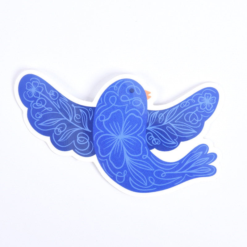 A blue sticker of a bird with floral patterns on its body and wings