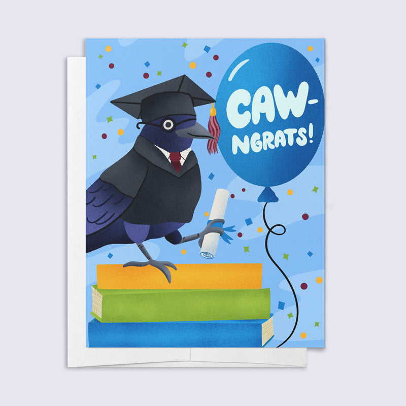 Graduation card with a cartoon crow in a cap and gown, holding a diploma, and a balloon saying 'CAW-NGRATS!' on a blue background.