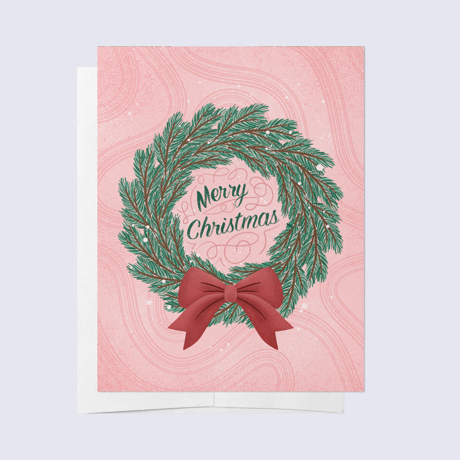 a greeting card that says "merry christmas" framed by a green wreath with a red bow
