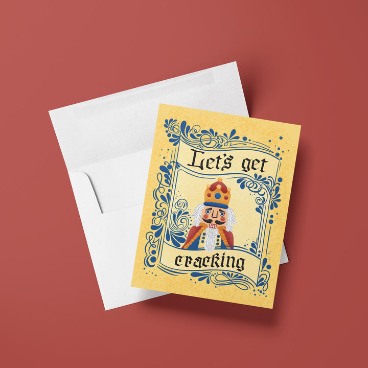 Greeting card with Nutcracker design and text 'Let's get cracking' on a red background