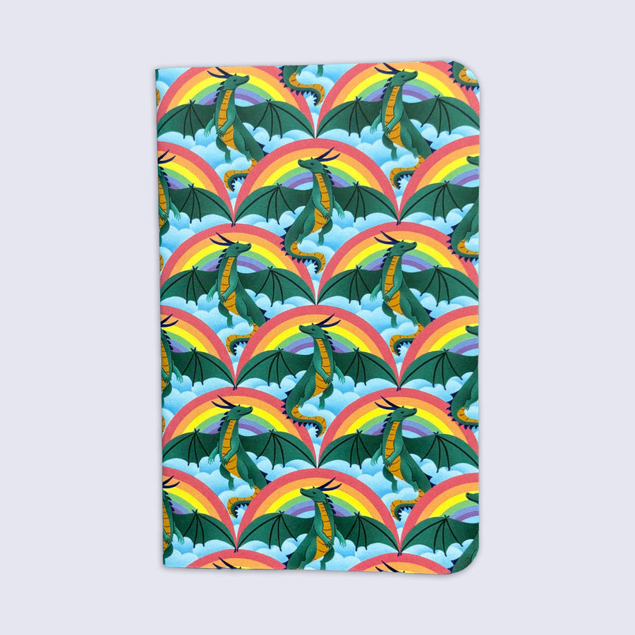 a small notebook with rounded corners featuring a pattern of dragons, rainbows, and clouds
