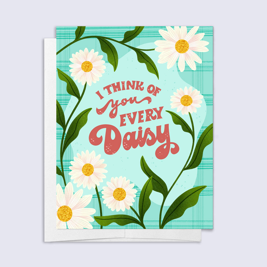Greeting card with daisies and text 'I think of you every daisy' on a blue background
