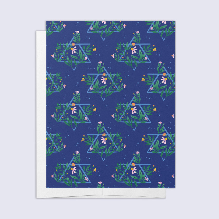 A greeting card with a floral design and a Jewish star pattern, with a blank interior and a bright white envelope.