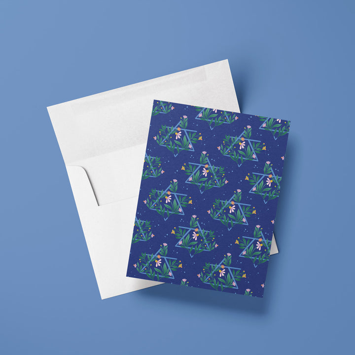 blue card with floral Jewish Star pattern against a green background
