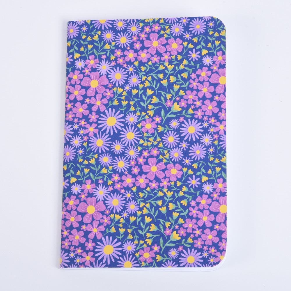 small pocket notebook featuring a floral design on  dark blue background