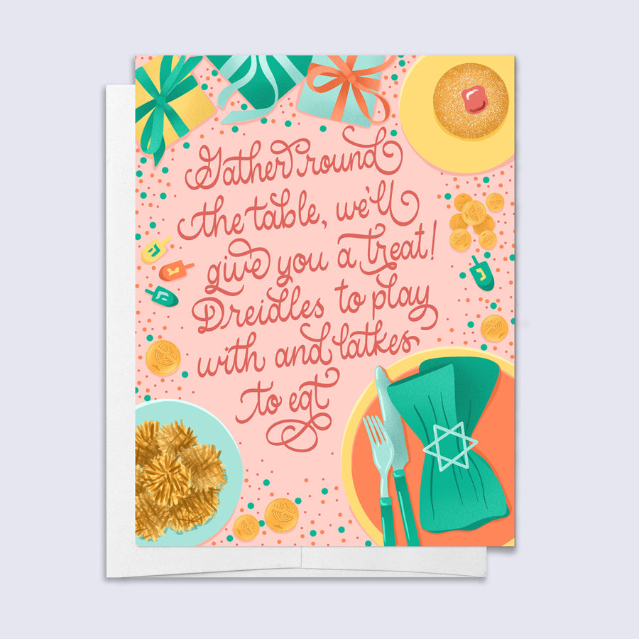 Hanukkah card featuring illustrations items around a dinner table and script lettering "gather round the table, we'll give you a treat! Dredels to play with and latkes to eat"