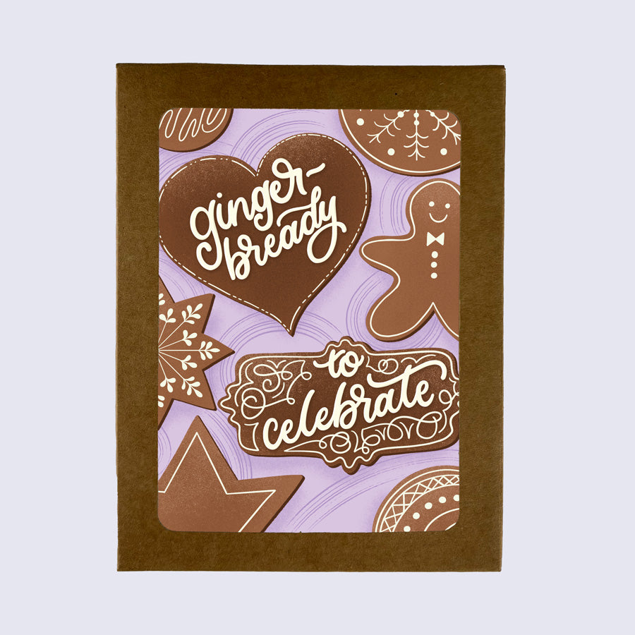 A greeting card with a gingerbread man design, along with stars, hearts, and text that reads 'Gingerbready to Celebrate'.