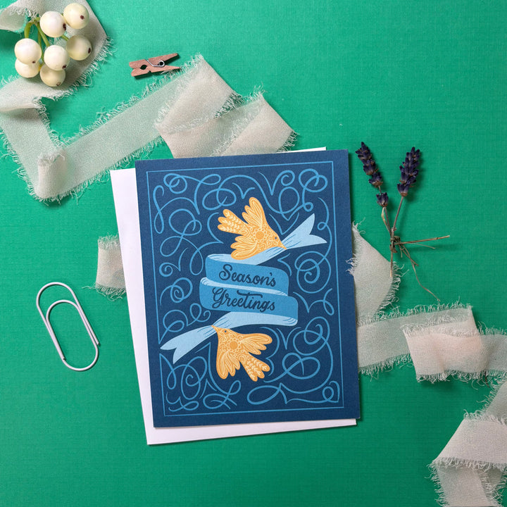 Greeting card with decorative elements on a green background