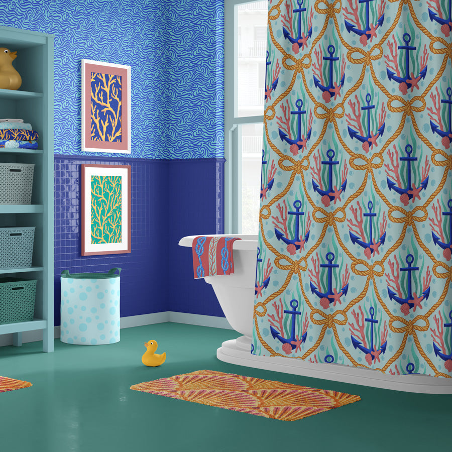 Bathroom with colorful anchor-patterned shower curtain, blue walls, and a rug.