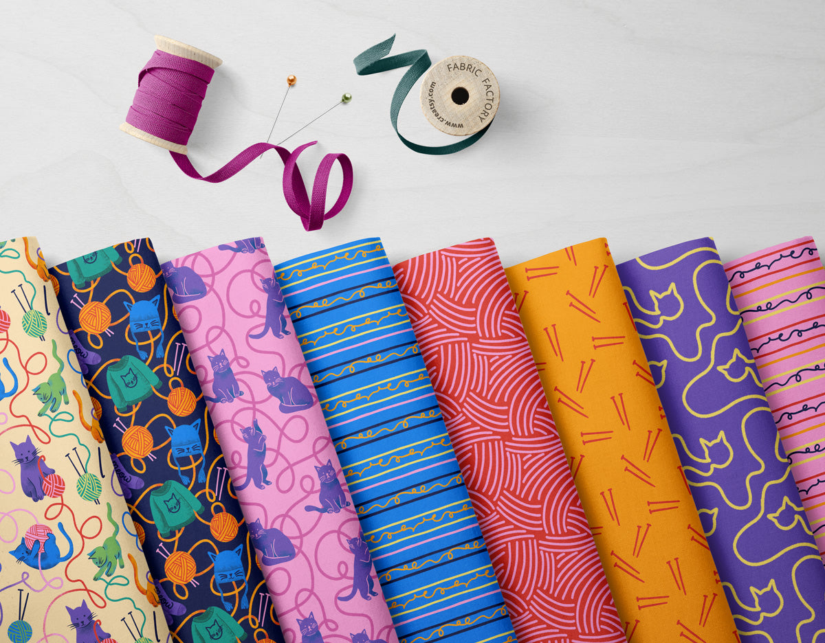 Collection of colorful fabric swatches with sewing tools on a light background