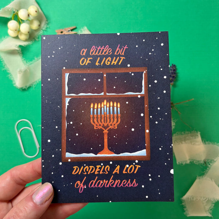 Card with Menorah illustration and text on a green background