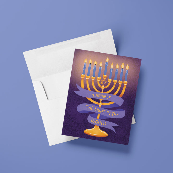 Card with Menorah illustration and banner that says "maccabee the light in the world"