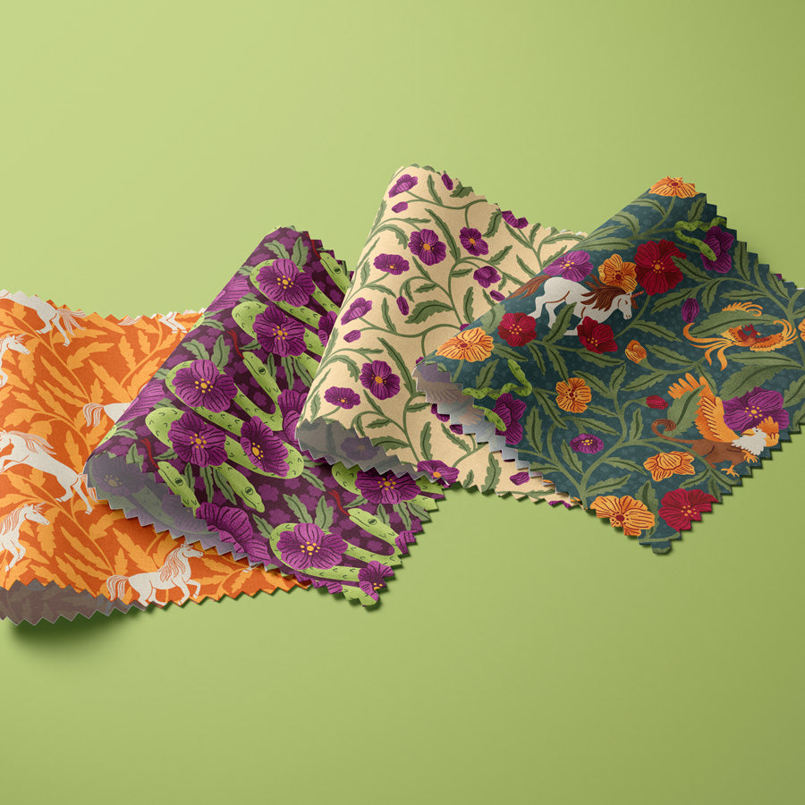 Colorful fabric swatches with floral and nature-themed patterns on a green background