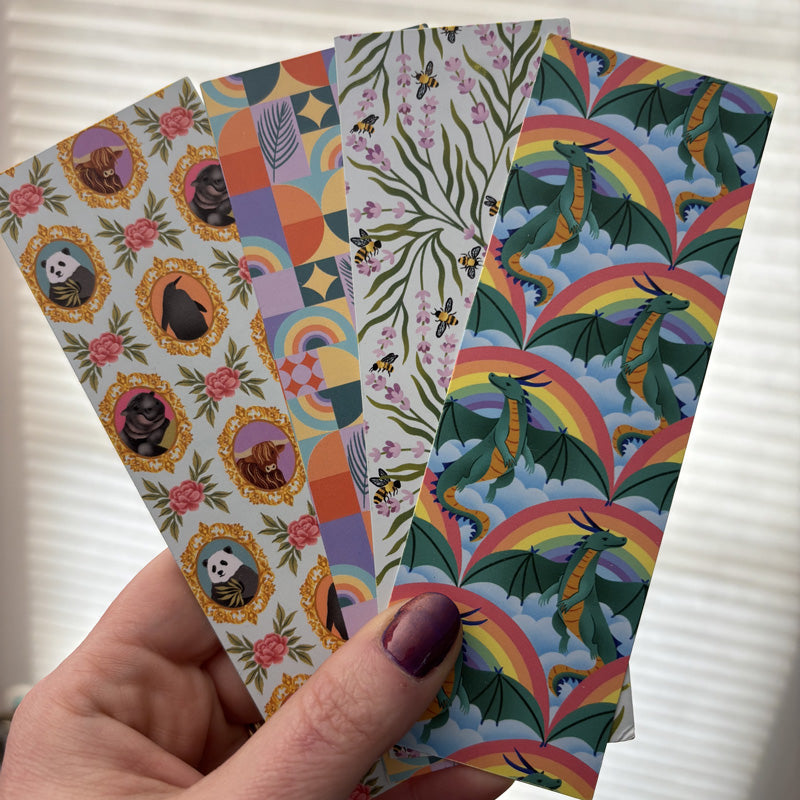 hand holding 4 bookmarks fanned out