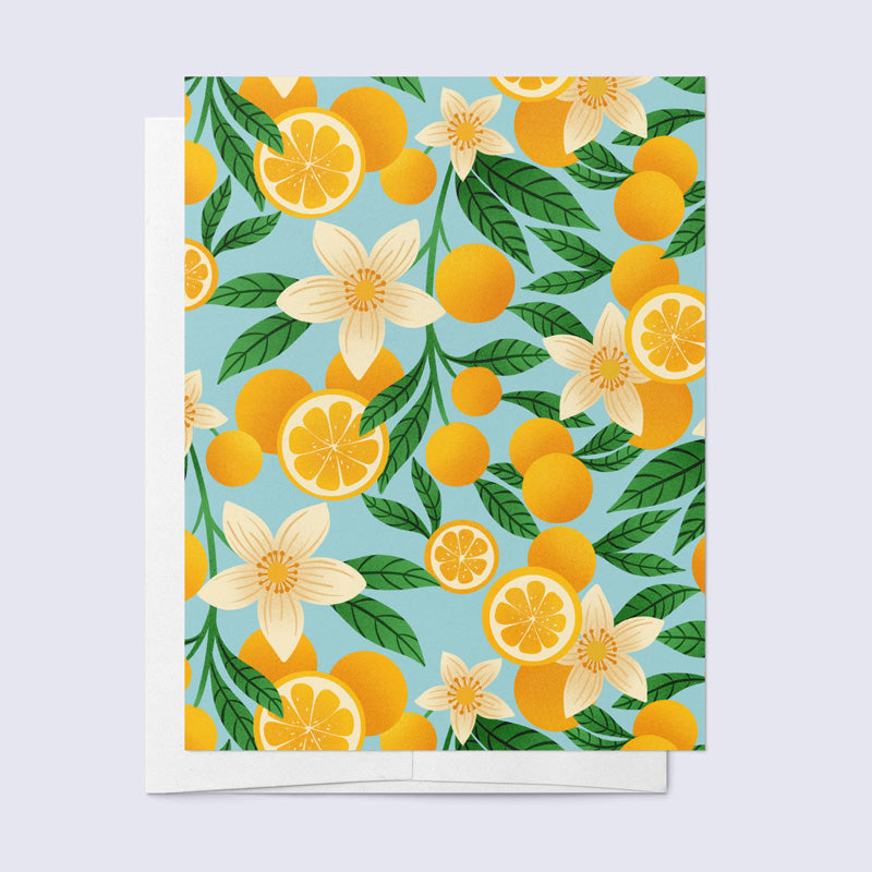 greeting card of oranges and orange blossoms on a light blue background