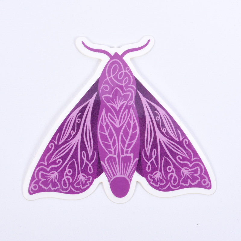 A purple sticker featuring a moth with floral patterns 