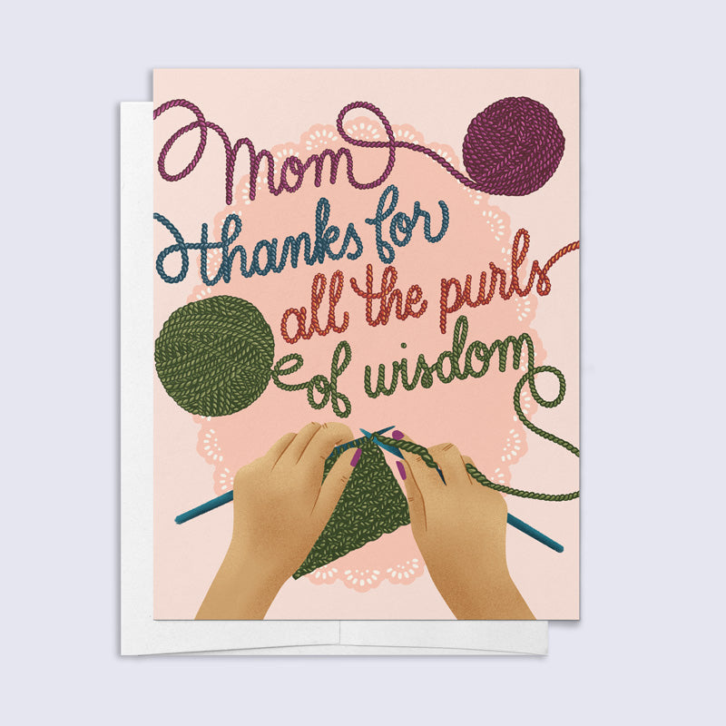Greeting card with hands knitting and text 'Mom, thanks for all the purls of wisdom' on a pink background.