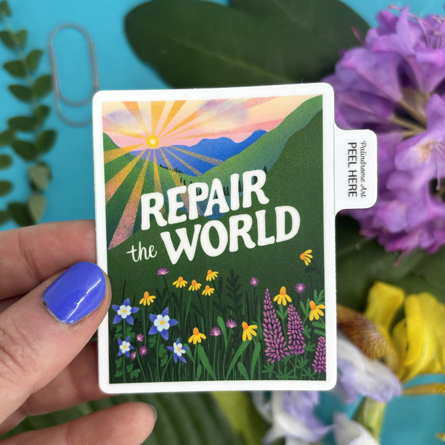 sticker with 'Repair the World' text held by a hand, surrounded by flowers and plants.