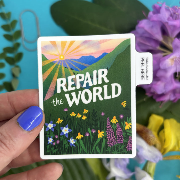 sticker with 'Repair the World' text held by a hand, surrounded by flowers and plants.