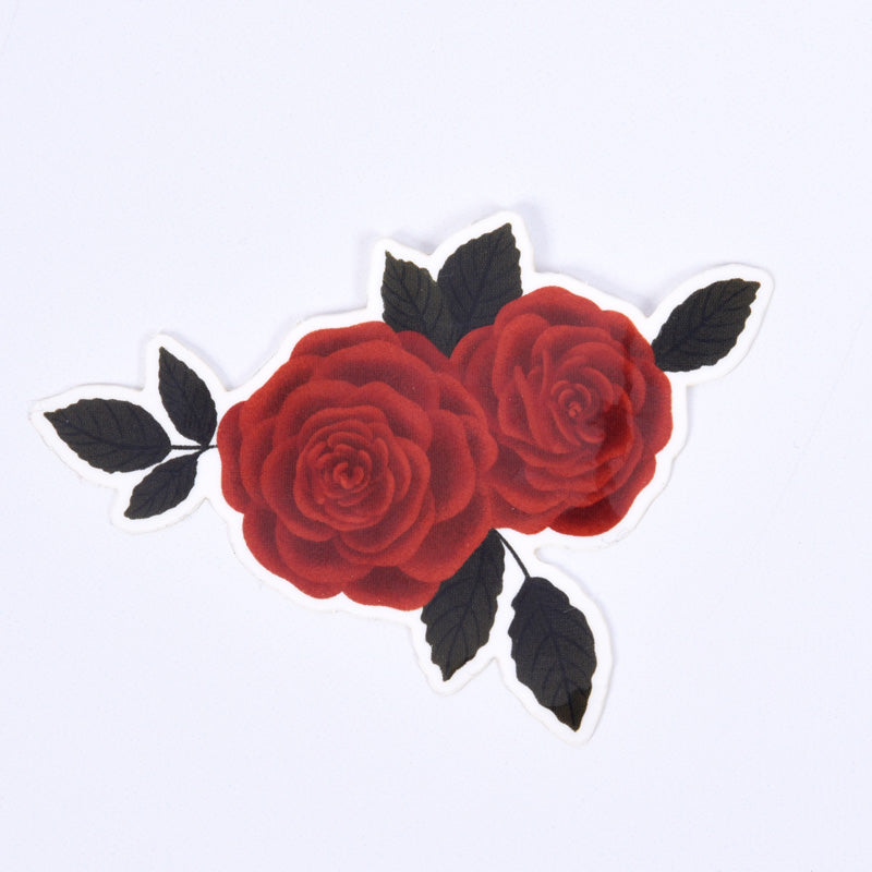 A sticker with an illustration of a red rose with dark green leaves on a white background.
