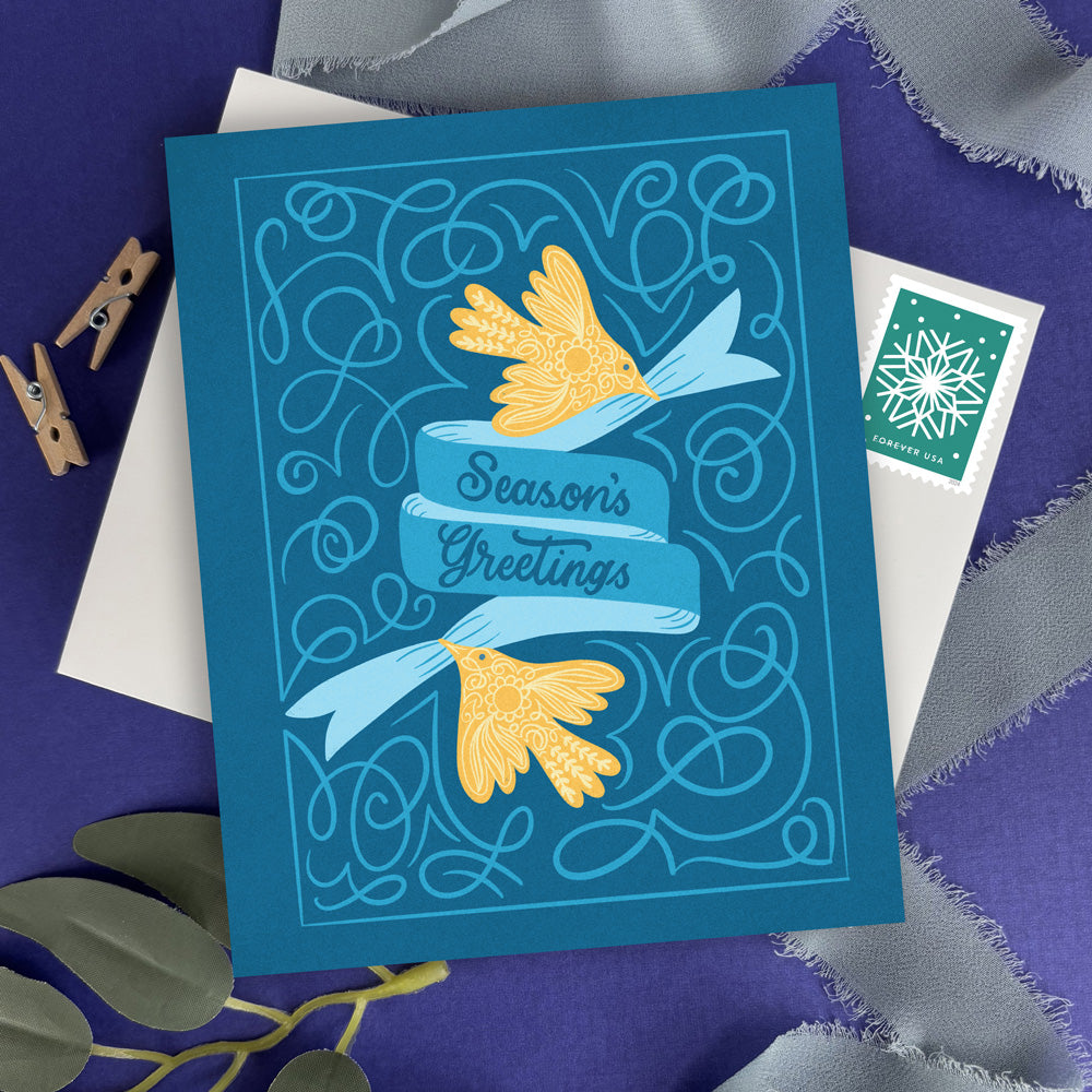 Season's Greetings card with decorative elements on a textured surface