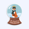 Vinyl sticker with illustration of a snow globe with a fox wearing a hat and scarf, that says "all dressed up snow where to go"