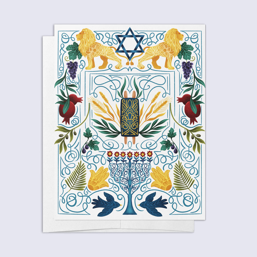 A folded greeting card with a colorful Jewish-themed design, featuring the Star of David, a Menorah, and other religious symbols, paired with a bright white envelope.
