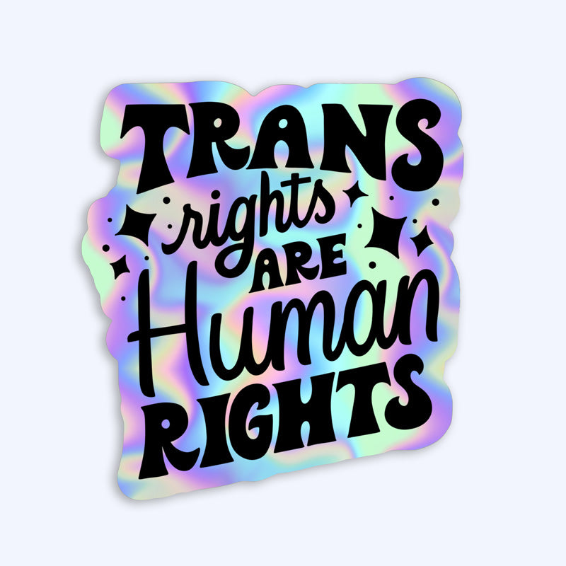 A sticker with text 'TRANS rights are Human rights' on a multicolored, holographic background.