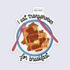 Sticker with waffles, fork, and knife on a plate with text 'I eat transphobes for breakfast' 