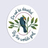 Circular sticker with a bird illustration and motivational quote on a light gray background